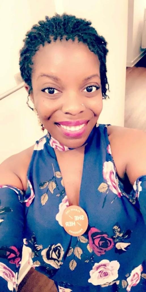 Short starter locs in floral dress smiling selfie