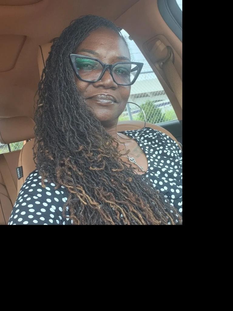 Brown twist locs in green jacket