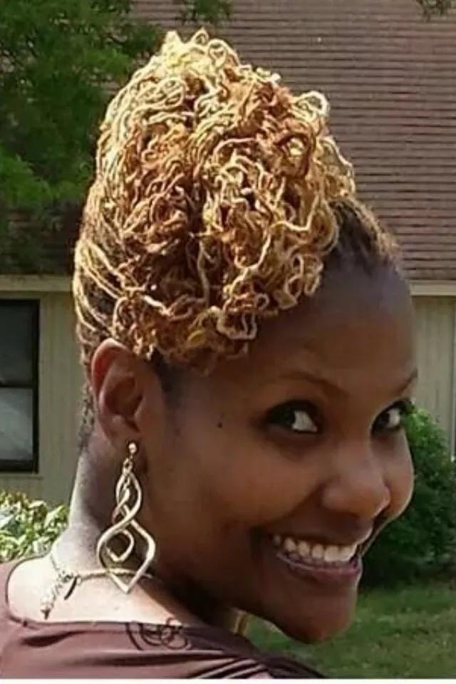 Blonde twisted updo hairstyle smiling